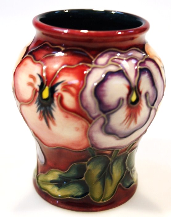 Appraisal: A Moorcroft Pansy pattern vase of shouldered circular form probably