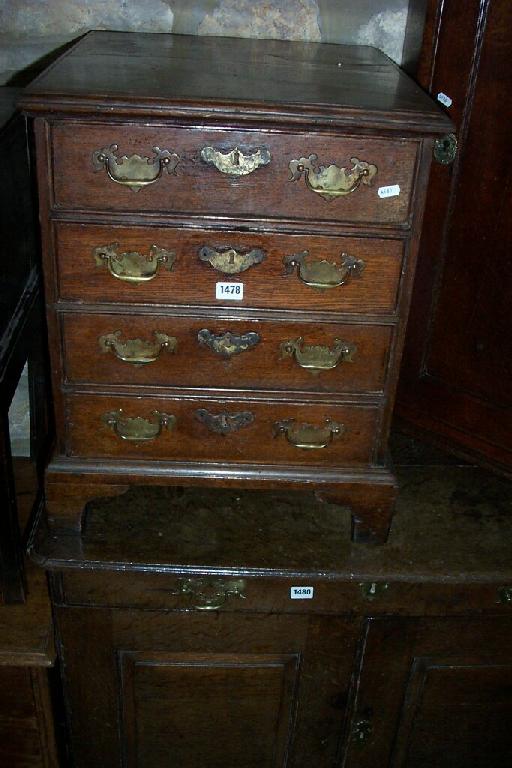 Appraisal: A small Georgian oak chest of long graduated drawers and