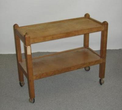 Appraisal: AN ADZED OAK TEA TROLLEY by Robert Mouseman Thompson of