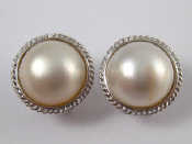 Appraisal: A pair of white metal tests carat gold mabe pearl