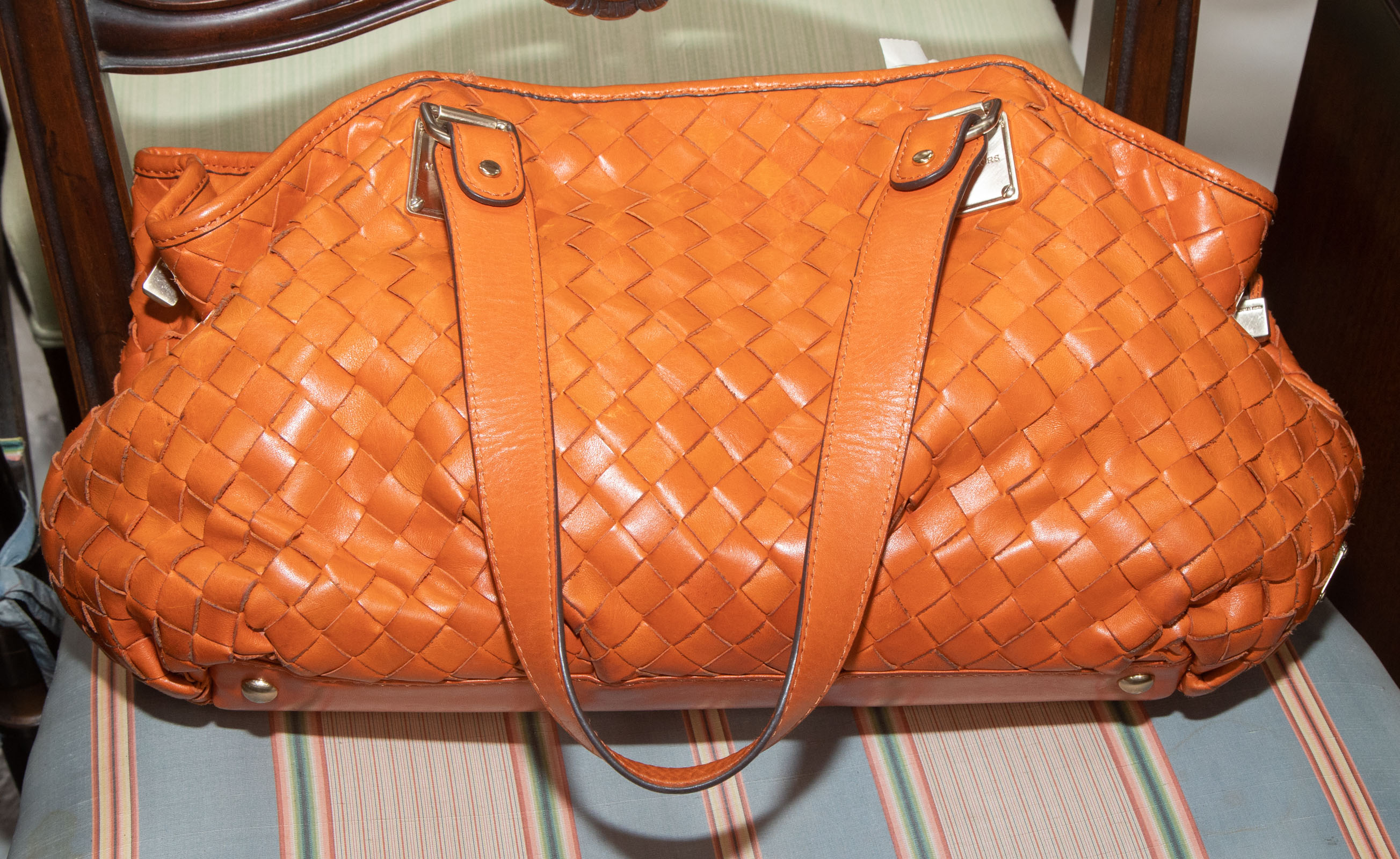 Appraisal: A MICHAEL KORS LEATHER HANDBAG An orange leather Michael Kors