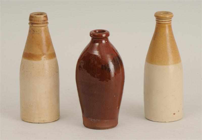 Appraisal: THREE POTTERY BOTTLES In brown or cream glaze to in