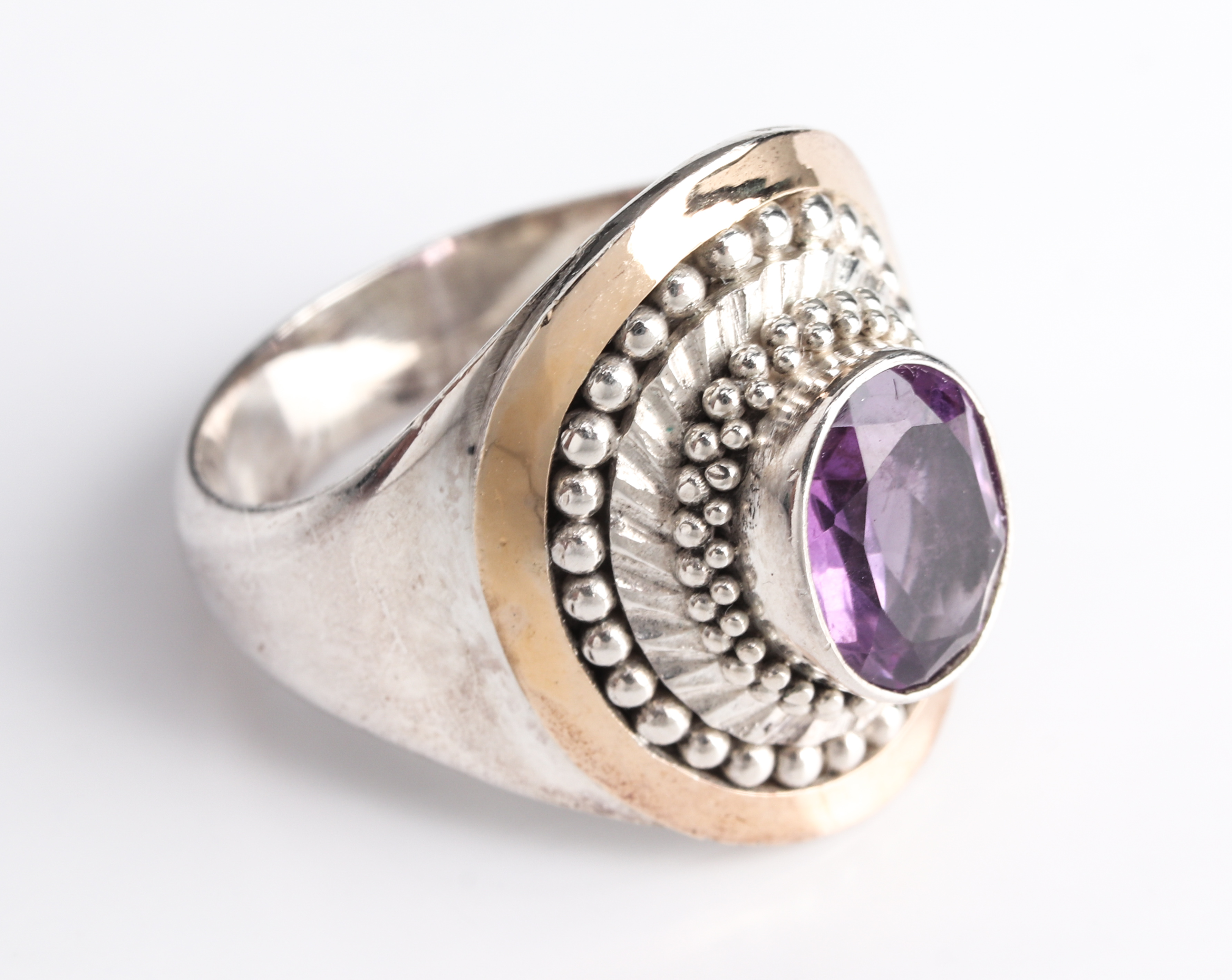 Appraisal: TRIBAL SILVER K YELLOW GOLD AMETHYST RING Tribal silver and