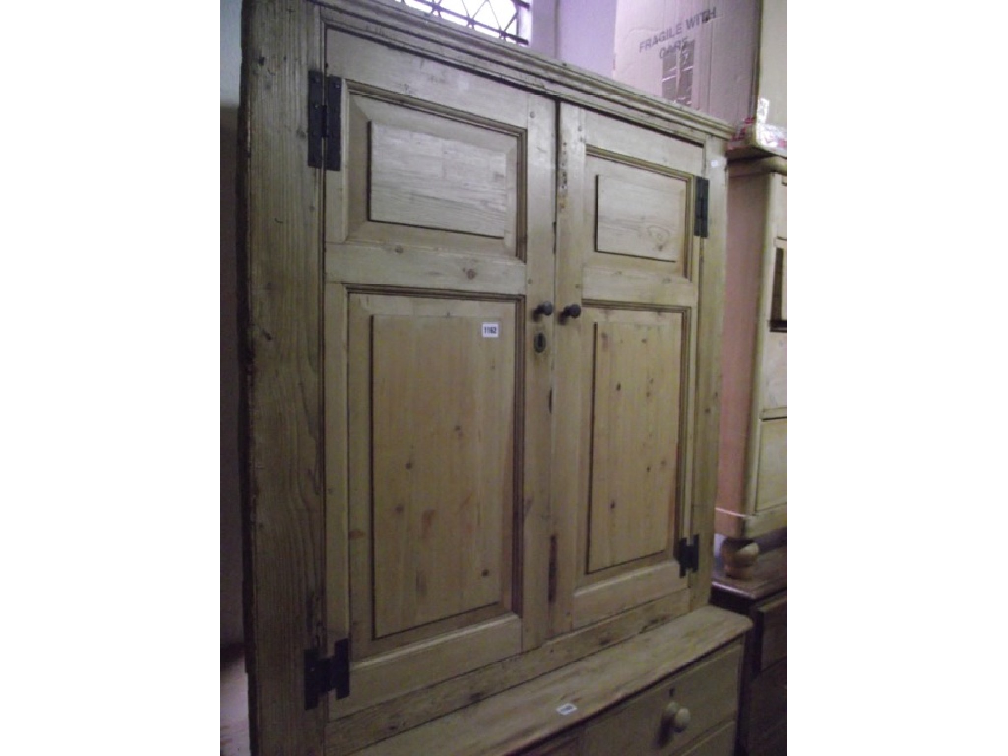 Appraisal: A reclaimed stripped pine hanging corner cupboard enclosed by a