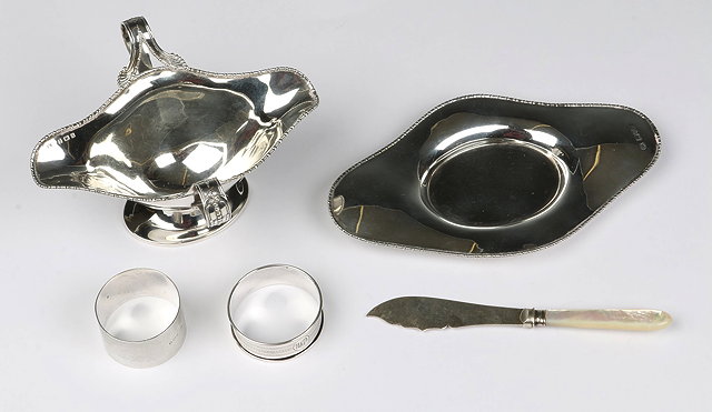 Appraisal: A DOUBLE ENDED SILVER SAUCE BOAT AND TRAY beaded border