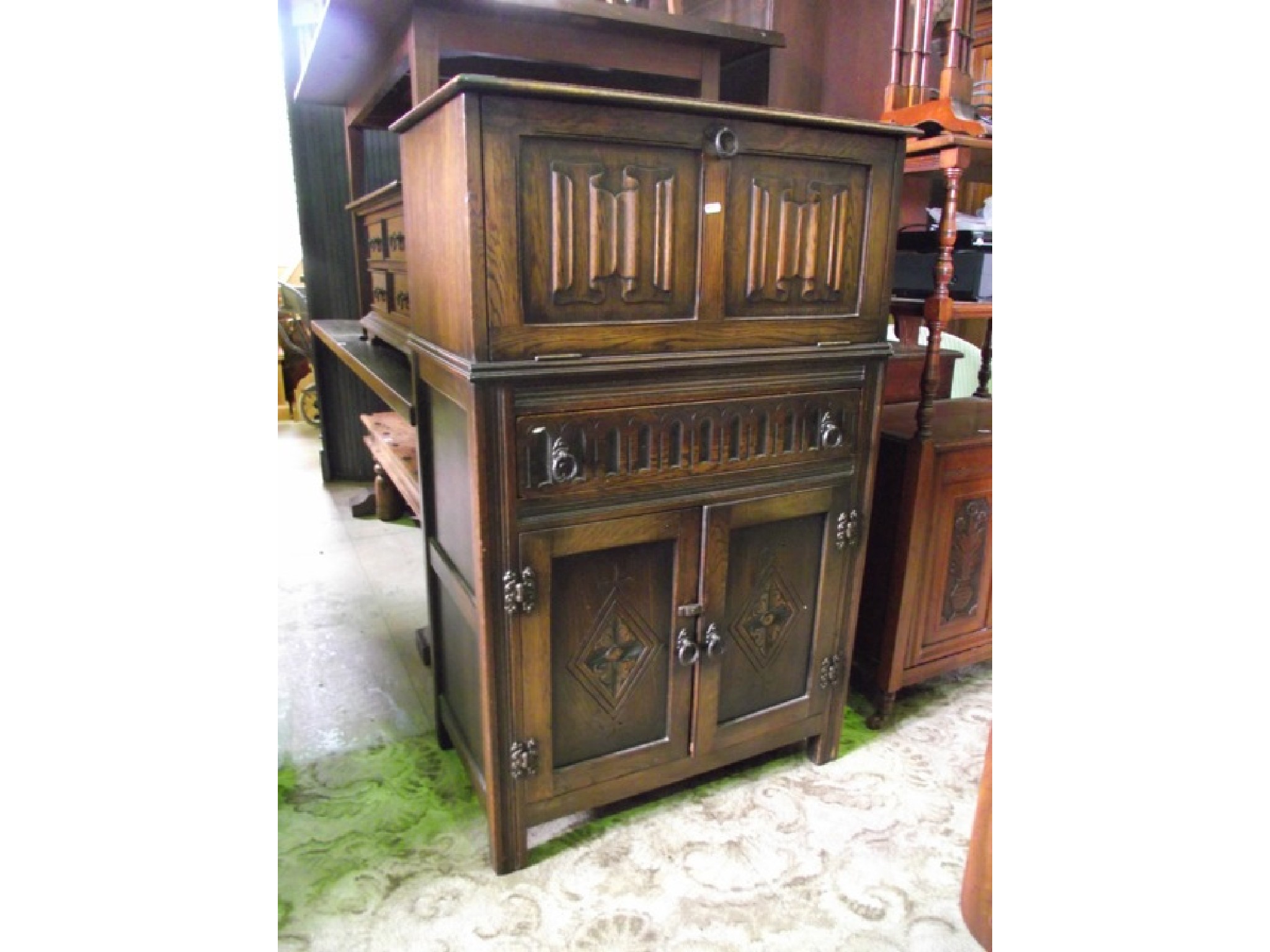 Appraisal: An oak freestanding cocktail cabinet in the form of an