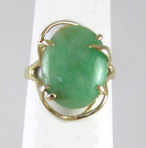 Appraisal: JADE AND FOURTEEN KARAT GOLD RING set with a single