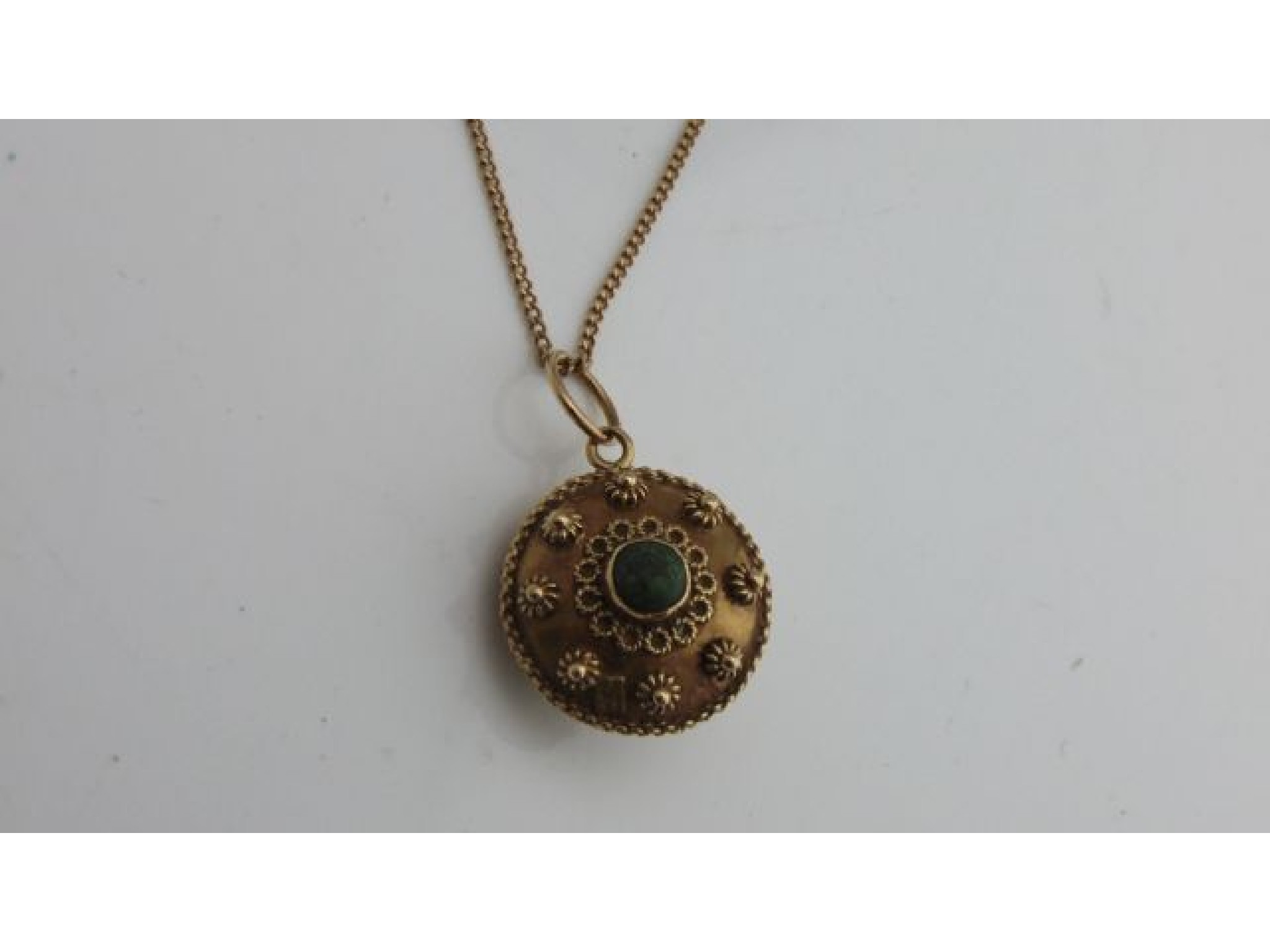 Appraisal: An ct gold pendant of circular form centred with a