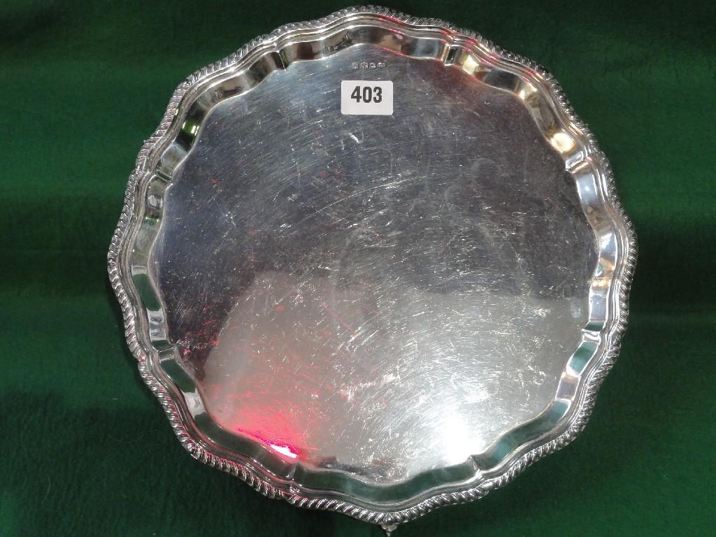 Appraisal: A silver salver with shaped gadrooned edge raised on three