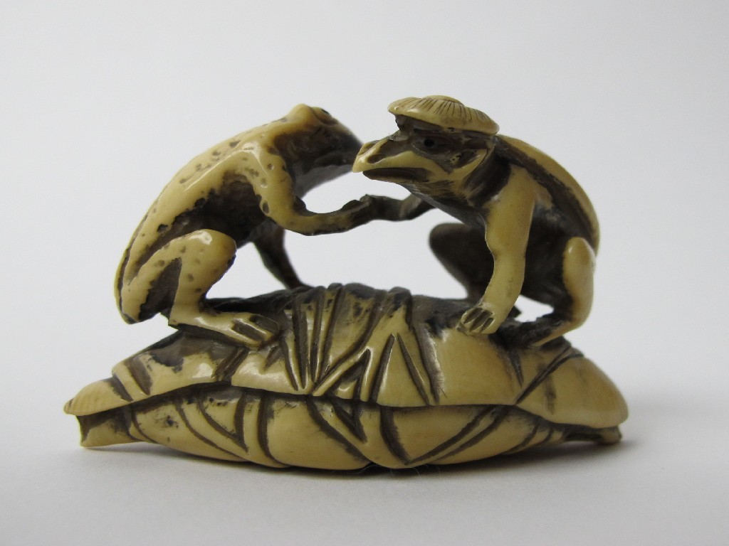 Appraisal: A Japanese carved ivory netsuke of a toad and a