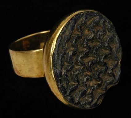 Appraisal: EARLY PERSIAN STEATITE AND GOLD RING Size stamp in diam