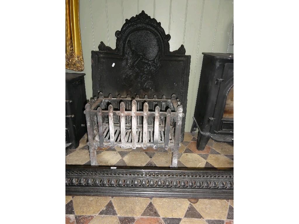 Appraisal: A heavy cast iron fire back of arched form with