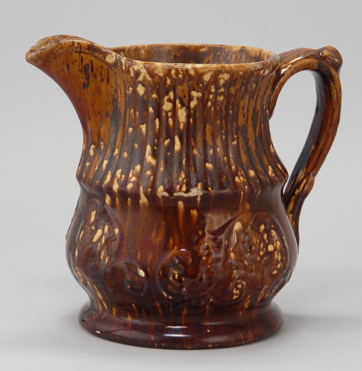 Appraisal: ANTIQUE ROCKINGHAM POTTERY CIDER PITCHER th CenturyFritting at lip Height