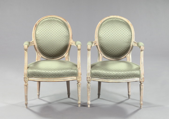 Appraisal: Pair of Louis XVI-Style Ivory-Painted Beechwood Armchairs each with a