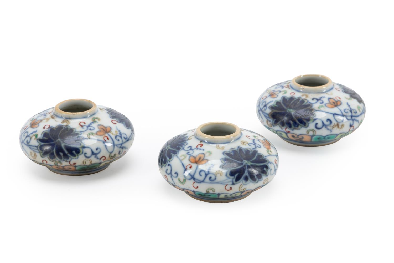 Appraisal: THREE SMALL CHINESE DOUCAI WATER DROPPERS Three small Chinese Doucai