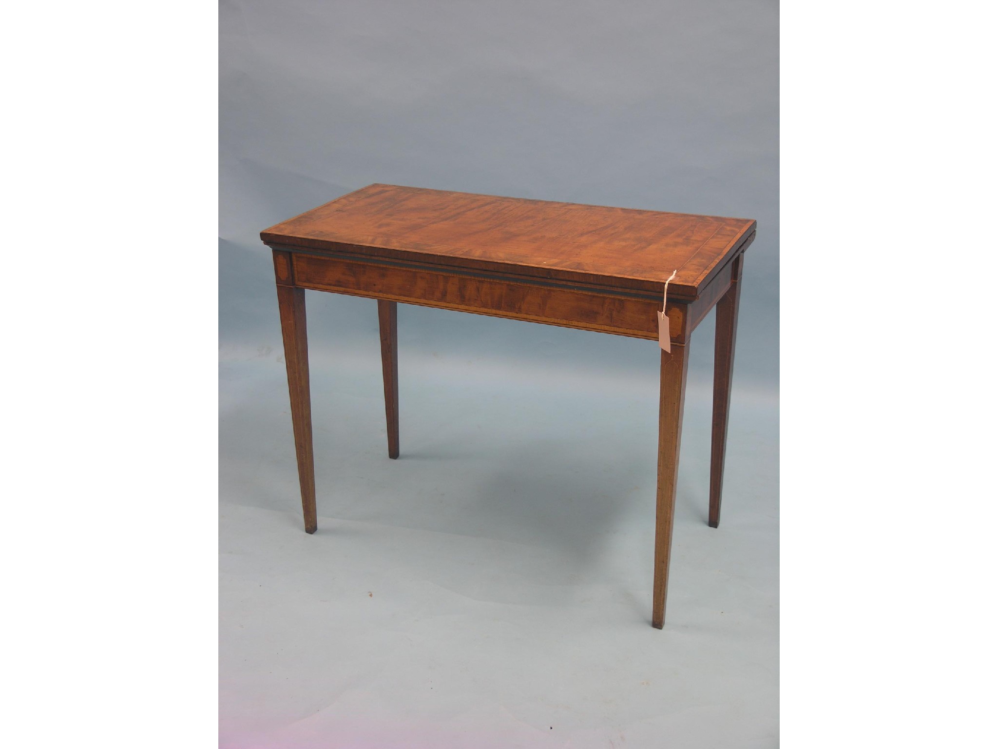 Appraisal: A Sheraton-period mahogany card table rectangular-shape with satinwood cross-banding throughout