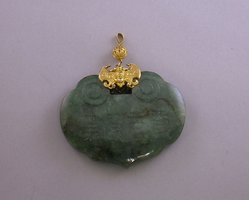 Appraisal: kt Gold and Carved Jade Pendant wd lg in not