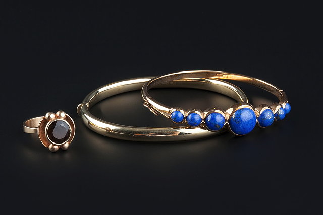 Appraisal: TWO BANGLES AND A DRESS RING comprising a ct gold