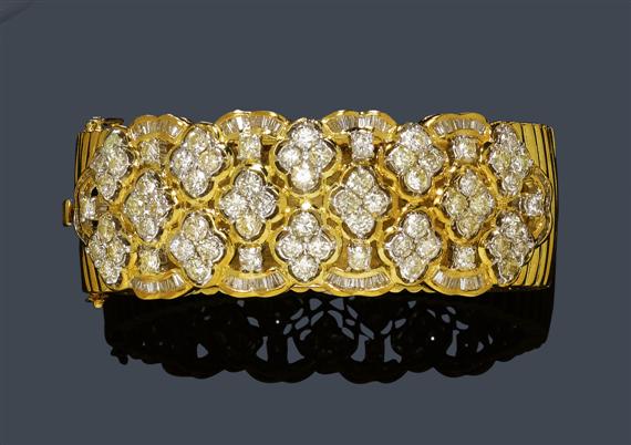 Appraisal: DIAMOND AND GOLD BANGLE Yellow gold g Decorative broad gadrooned