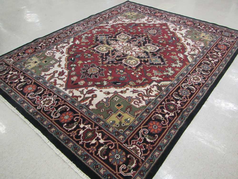 Appraisal: HAND KNOTTED ORIENTAL CARPET Indo-Heriz central geometric medallion and stylized