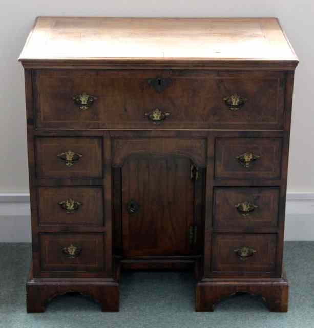 Appraisal: A late th Century walnut kneehole desk the crossbanded top