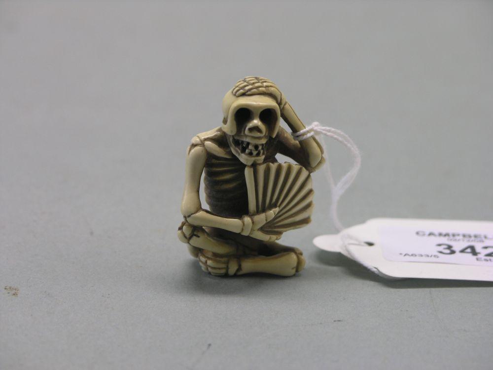 Appraisal: A Japanese ivory ojime Meiji period a skeleton seated with