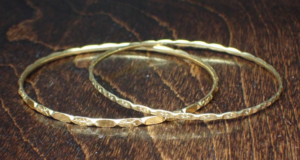 Appraisal: TWO ROUND YELLOW GOLD BANGLE BRACELETS including an k yellow