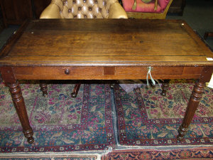 Appraisal: A French oak writing table the moulded top above two