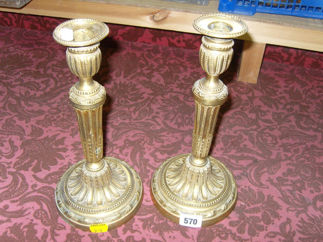 Appraisal: A pair of th century cast brass candlesticks with reeded