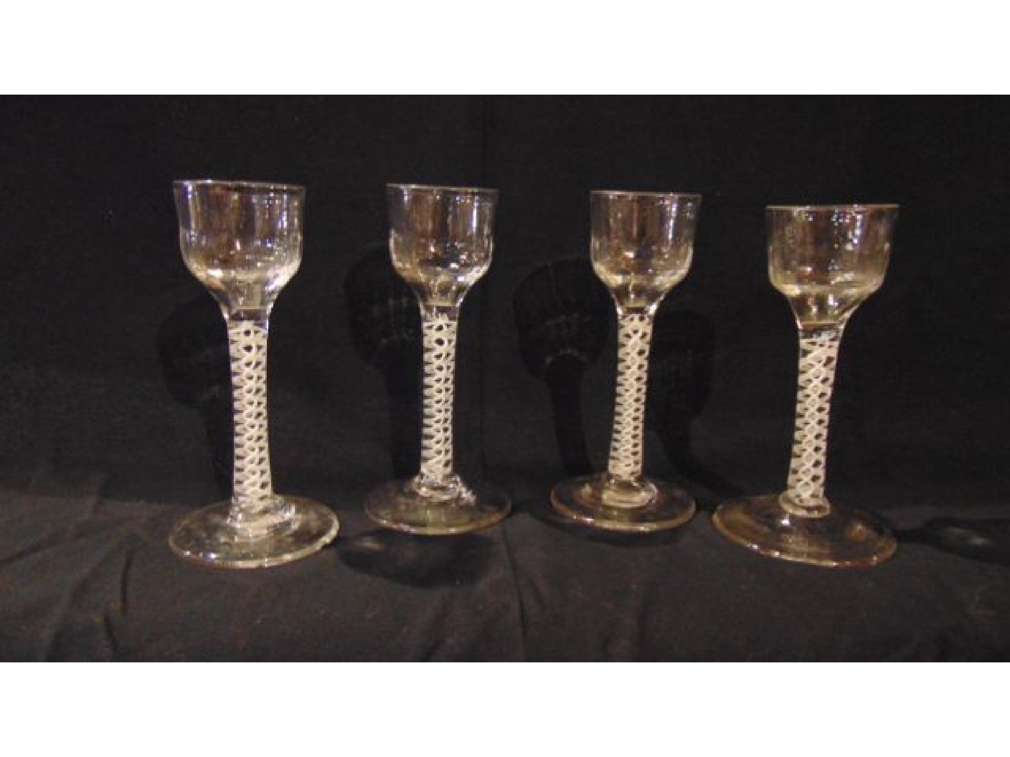 Appraisal: Four matching Georgian cotton twist drinking glasses each simple stem