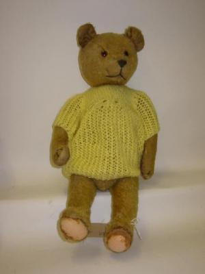 Appraisal: A pre-war teddy bear straw filled covered in gold plush