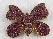 Appraisal: A yellow metal tests ct gold garnet set butterfly brooch