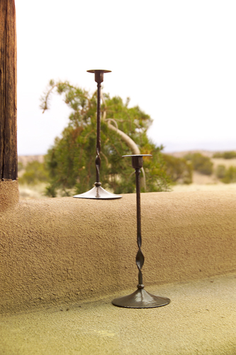 Appraisal: ROYCROFT Tall hammered copper candlesticks with twisted stems on broad