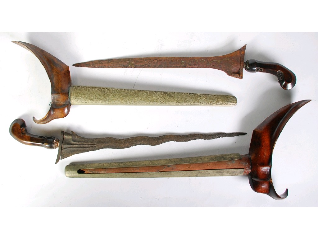 Appraisal: TWO MALAY KRIS with wooden hilts and grips with white