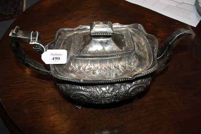 Appraisal: A GEORGE III IRISH SILVER TEAPOT oval shaped with chased