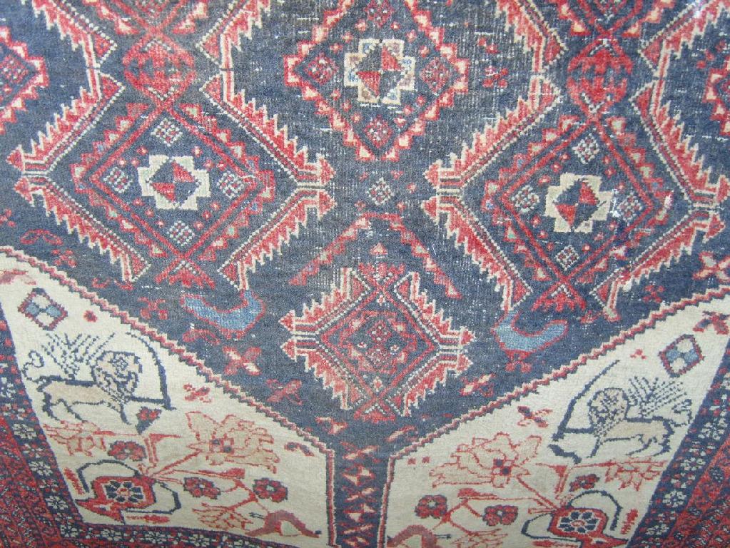 Appraisal: A small eastern wool rug with stylised lion and floral