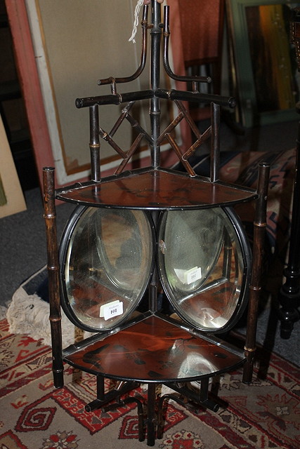 Appraisal: AN EBONISED BAMBOO CORNER SHELF with mirrors and lacquered decoration