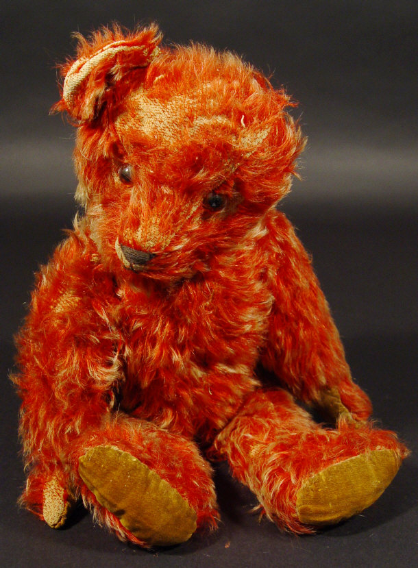 Appraisal: Red plush jointed teddy bear with straw filled body and