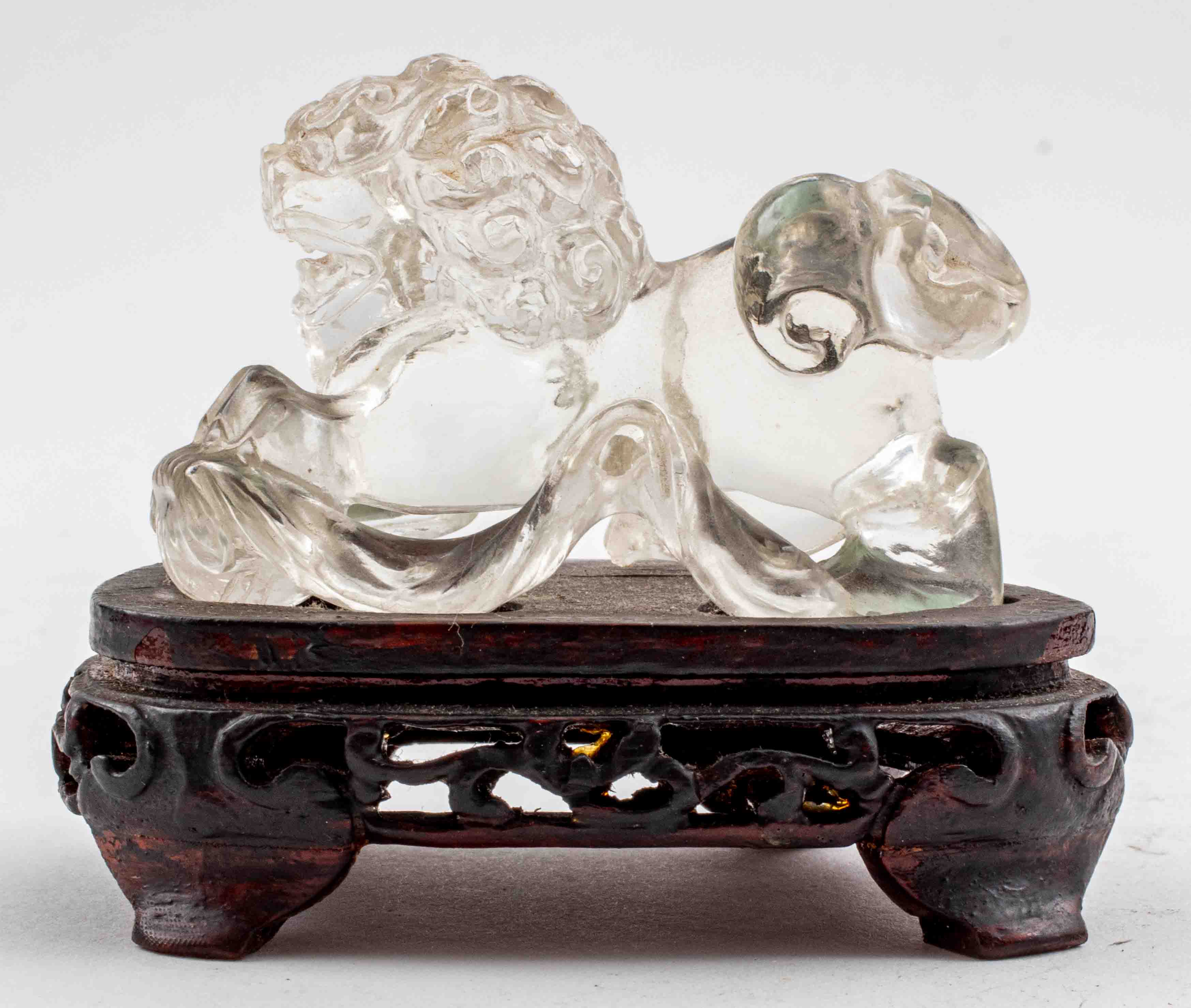 Appraisal: ASIAN ROCK CRYSTAL CARVING OF A FOO LION ON WOOD