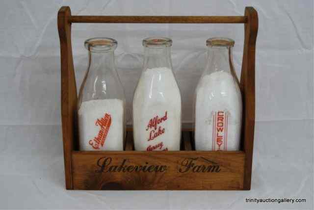 Appraisal: Vintage Milk Bottles Crate CarrierIncludes vintage milk bottle with cardboard