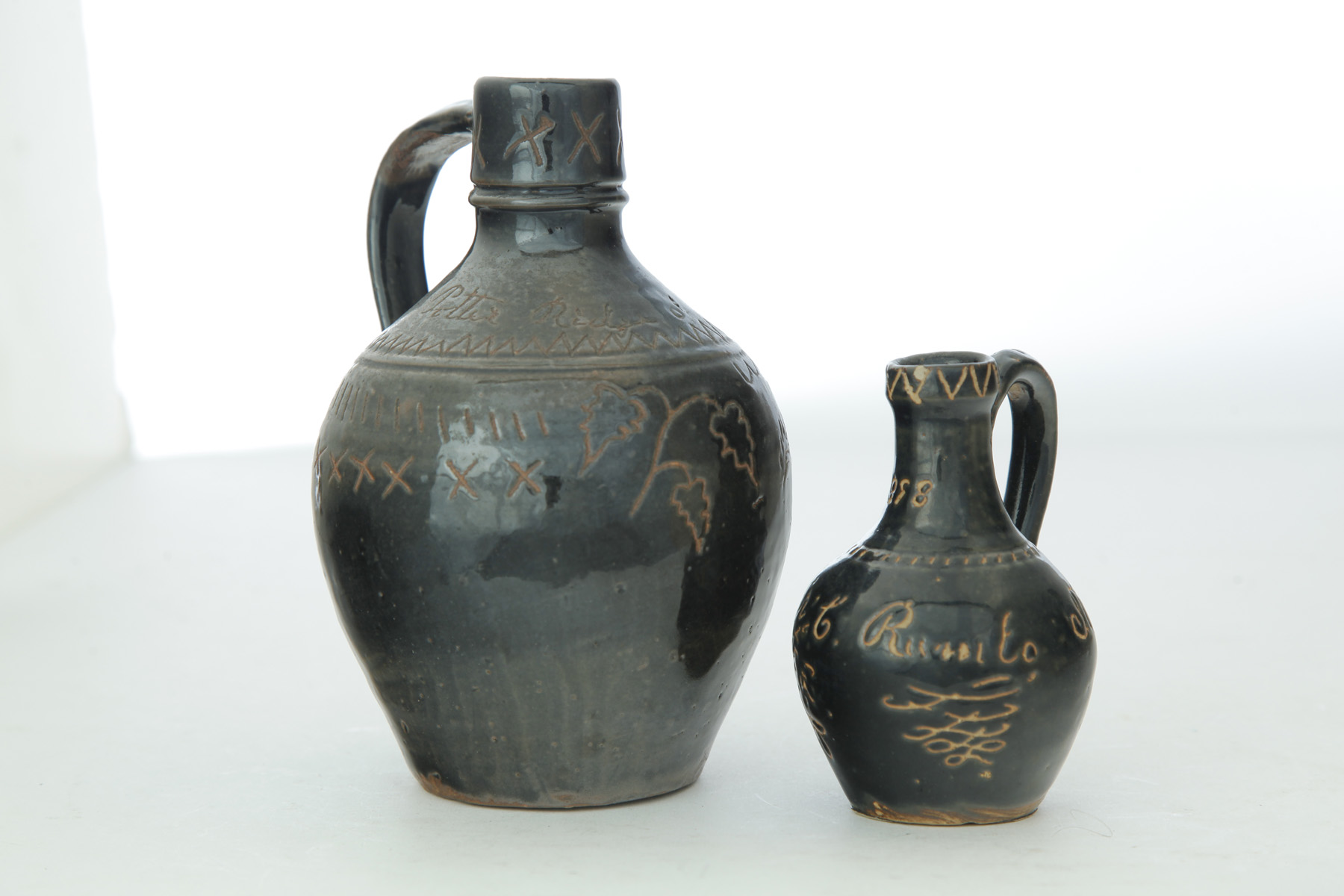 Appraisal: TWO VINTON COUNTY OHIO SGRAFFITO-DECORATED JUGS Late th-early th century