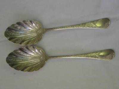 Appraisal: A PAIR OF GEORGE III SERVING SPOONS the shell bowls