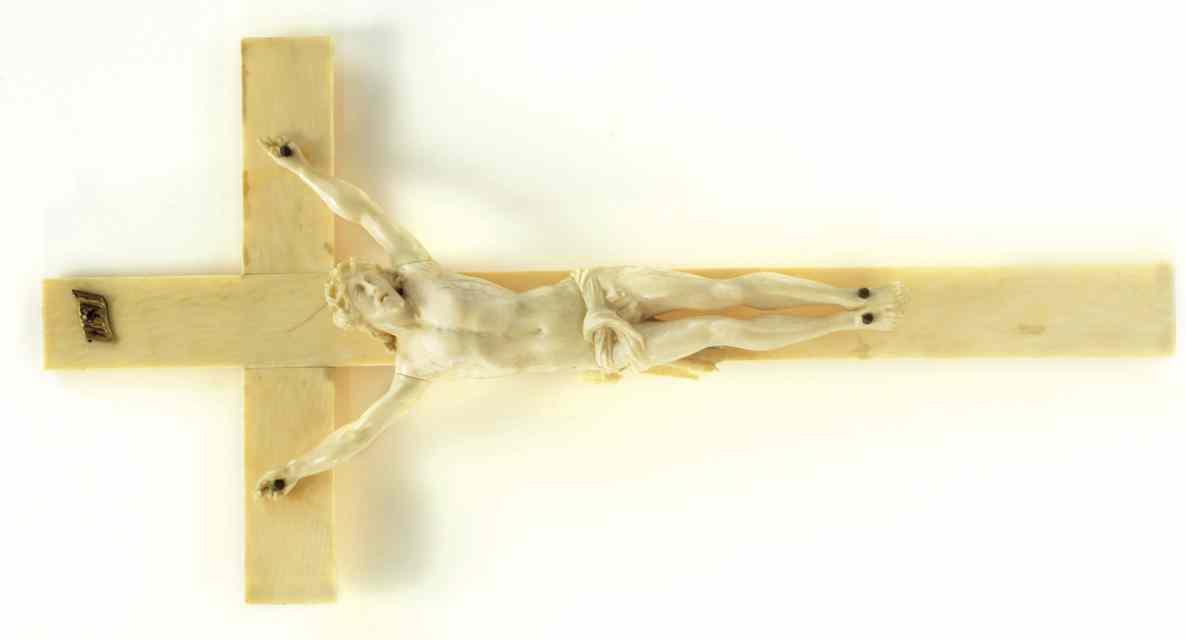 Appraisal: AN IVORY CARVED CRUCIFIX the corpus '' long with INRI