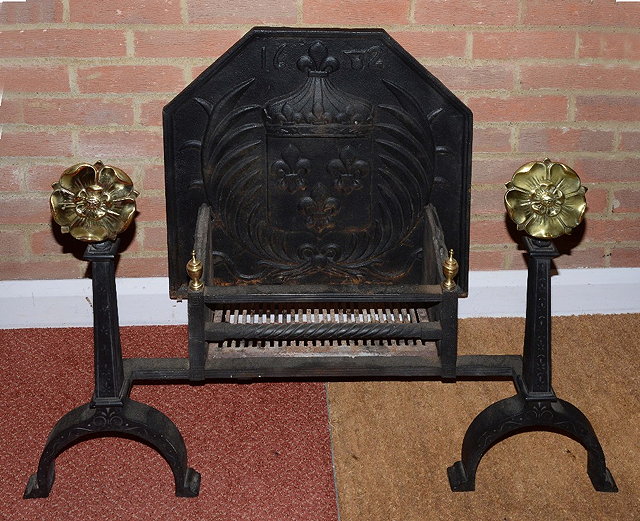 Appraisal: A CAST IRON FIRE BASKET with brass Tudor rose ornament