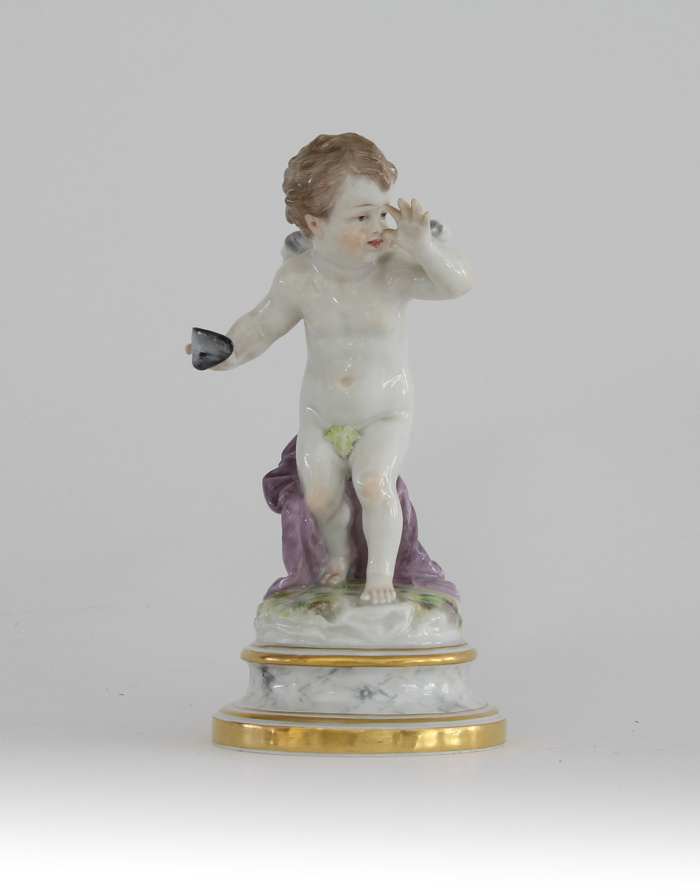 Appraisal: A Meissen figure the playful cherub a mask in his