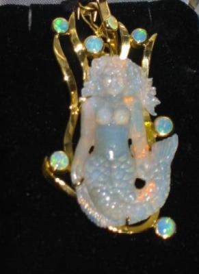 Appraisal: A LARGE OPAL PENDANT the central opal carved as a