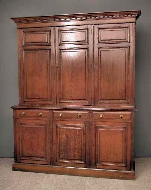 Appraisal: A late Victorian housekeeper's panelled oak cupboard with moulded and