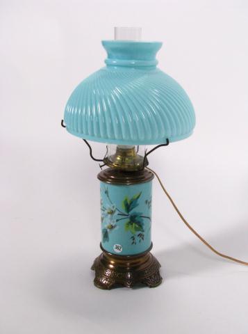 Appraisal: Green glass hurricane lamp with enamel decorated base and swirl