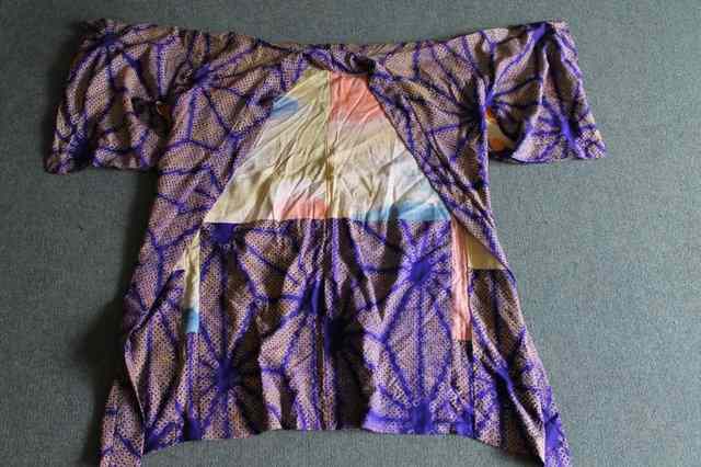 Appraisal: A PURPLE JAPANESE SILK KIMONO OR HAROI printed with gold