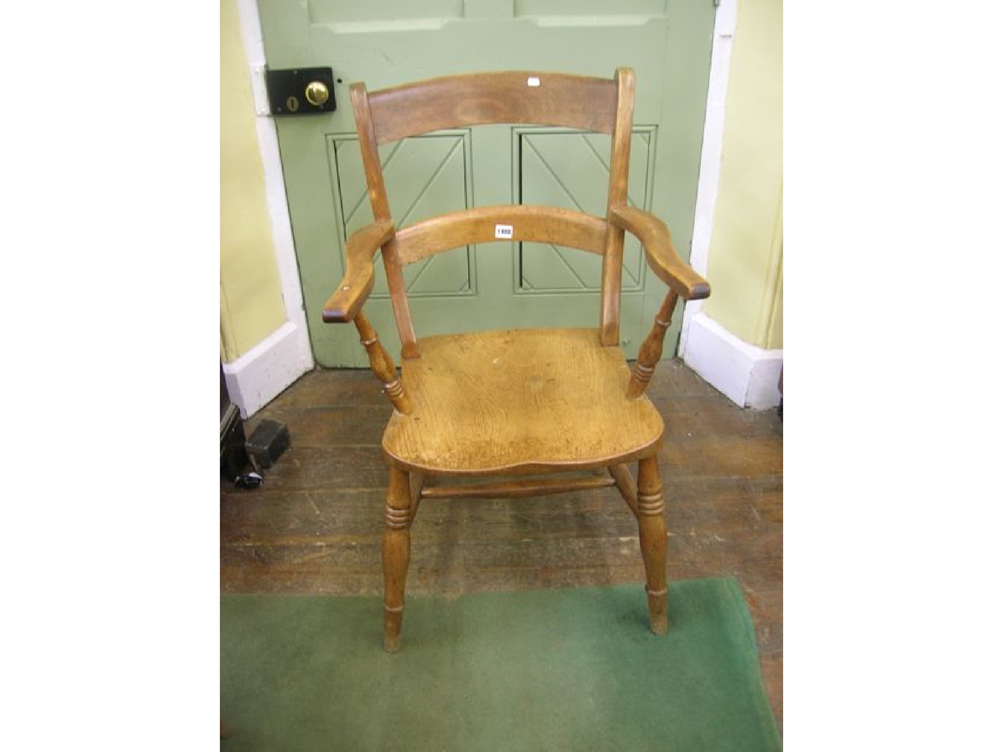 Appraisal: A Victorian Windsor bar back elbow chair with figured elm